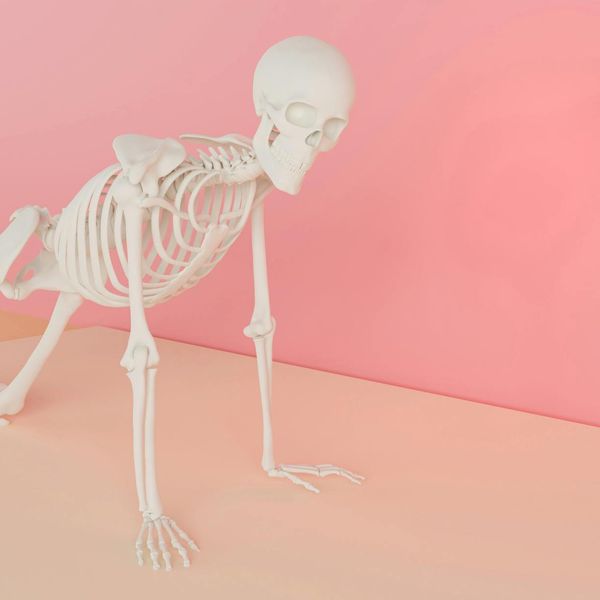 Person in a balancing yoga pose against a minimal background.