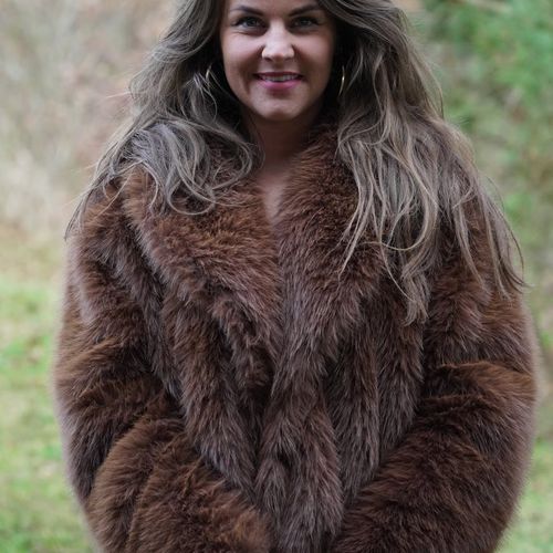 Portrait of a smiling woman in a cozy setting.
